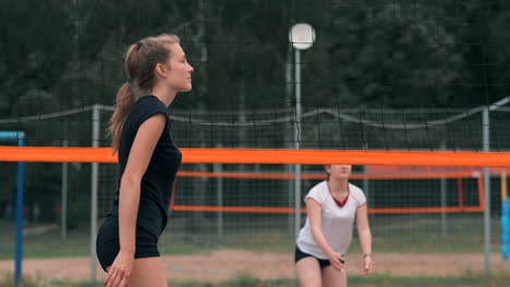 Mujer-Joven-Jugando-Voleibol-En-La-Playa-En-Un-Equipo-Que-Lleva-A-Cabo-Un-Ataque-Golpeando-La-Pelota.-Chica-En-Cámara-Lenta-Golpea-La-Pelota-Y-Realiza-Un-Ataque-A-Través-De-La-Red.